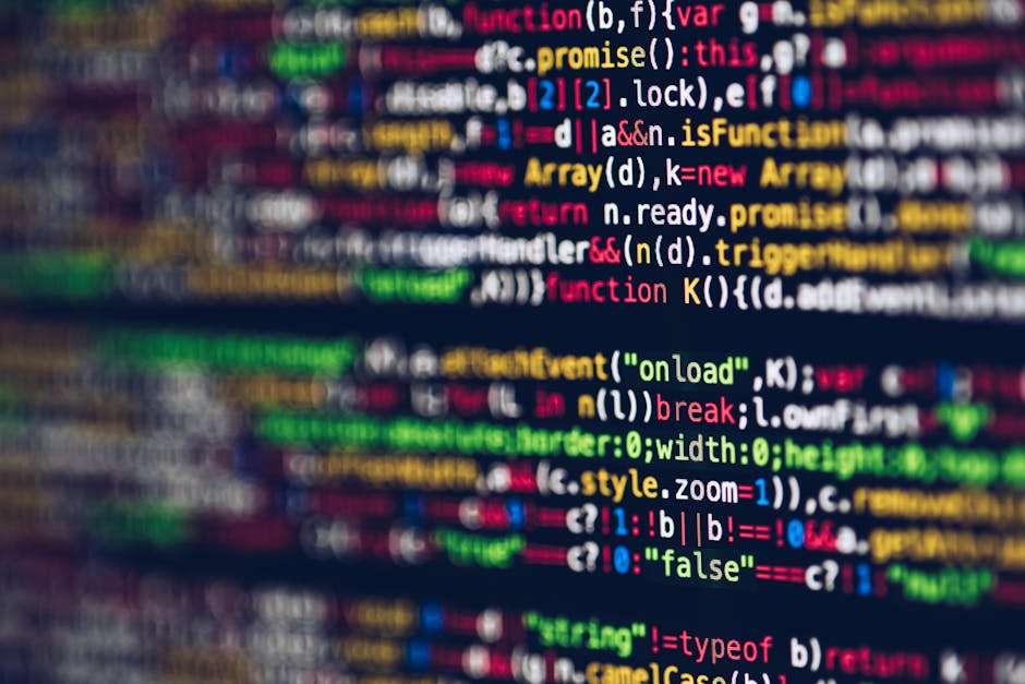 A close-up photograph of a computer screen displaying colorful lines of code, including keywords like 'function', 'var', 'return', and 'style', rendered in various hues such as red, green, blue, and y